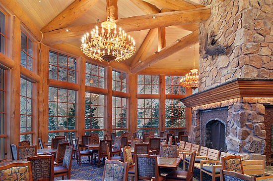 Half log trusses circle the fireplace in the John Paul day lodge at Snowbasin Resort, Utah
