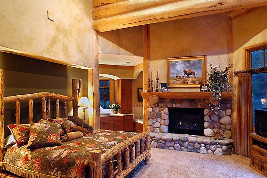 log mantle and contrasting drywall in this log house