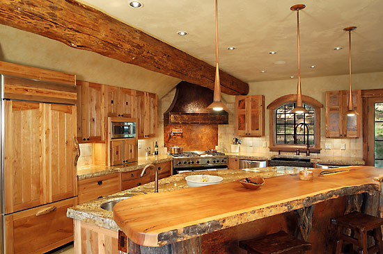 This hybrid log home features a large pine beam through the kitchen