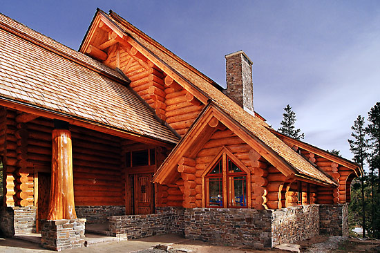Handcrafted log home featuring large cedar flare posts